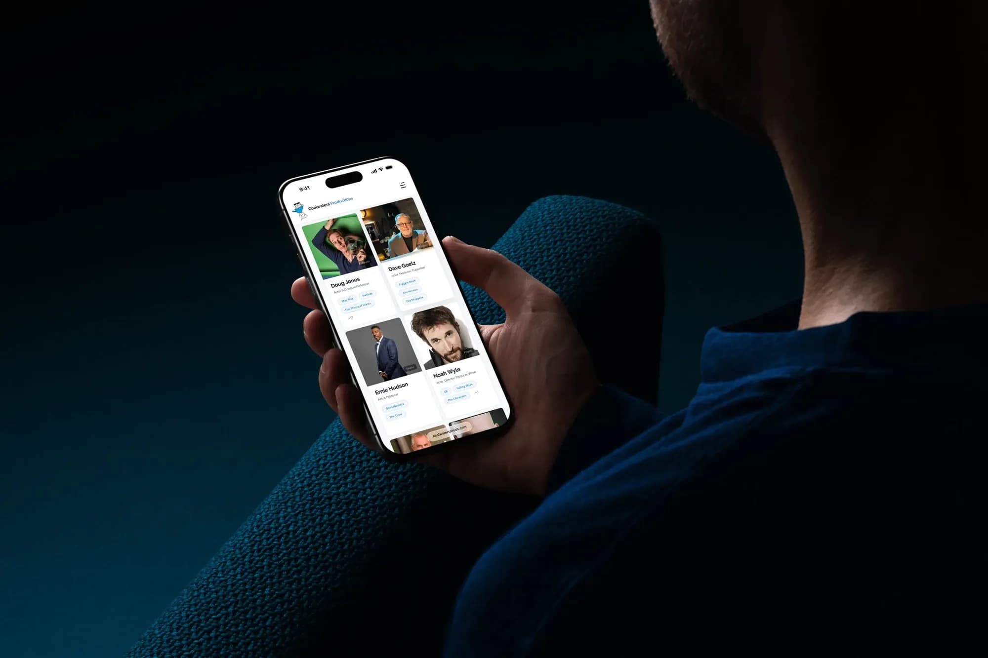 The Coolwaters talent roster on a phone, held by someone on a sofa