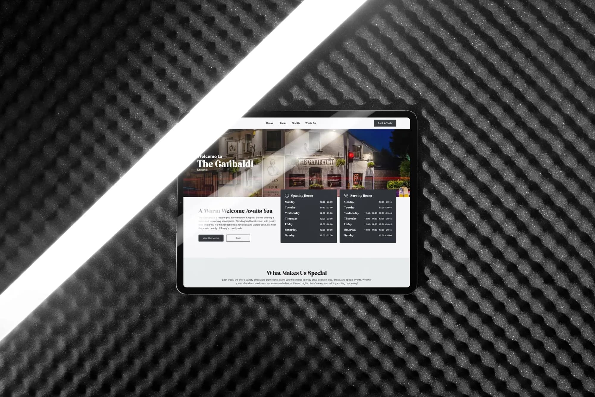 The Garibaldi homepage on an iPad, lying on black acoustic foam under a strip of light