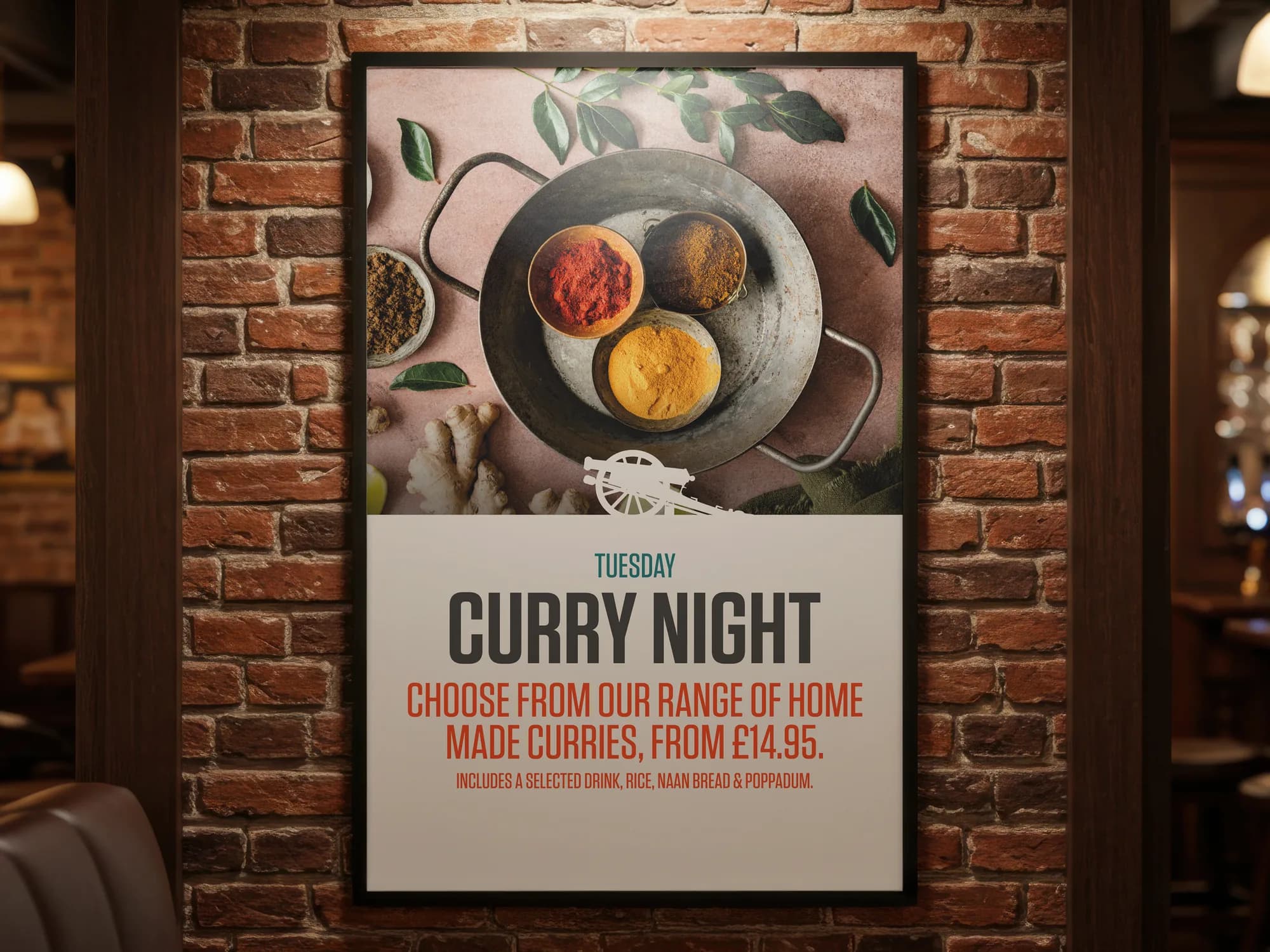 A framed Tuesday curry night poster on a brick wall inside the pub, lit from above