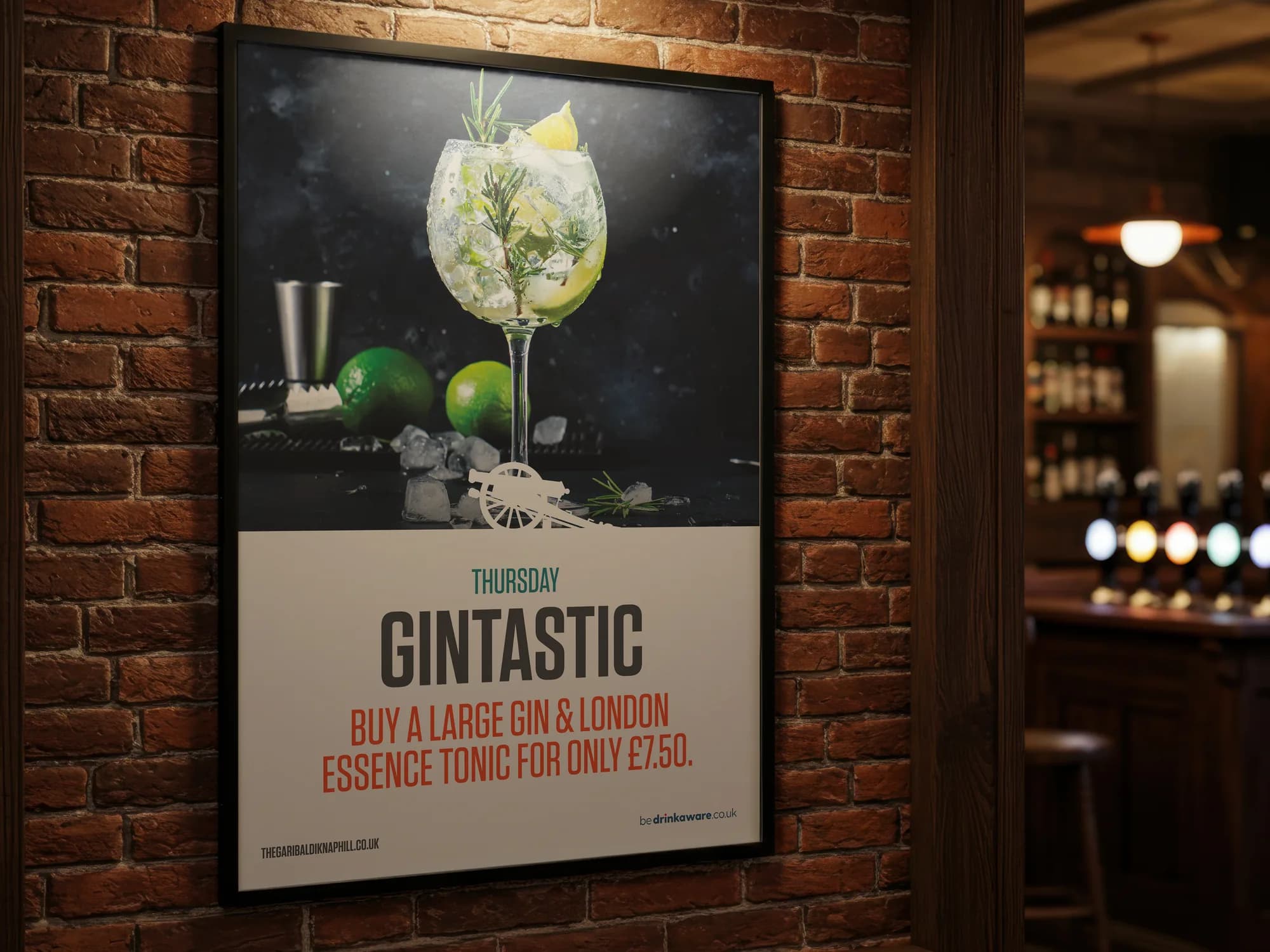 A framed Thursday Gintastic poster on a brick wall, with the bar out of focus behind