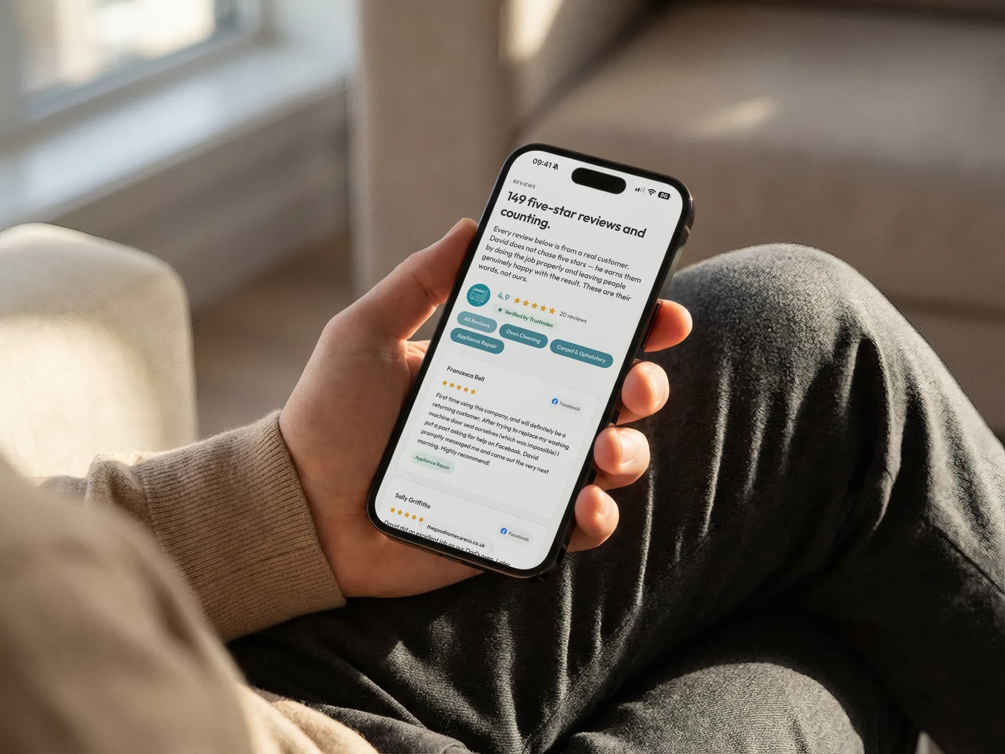 The reviews page on a phone held in a hand: 149 five-star reviews and counting