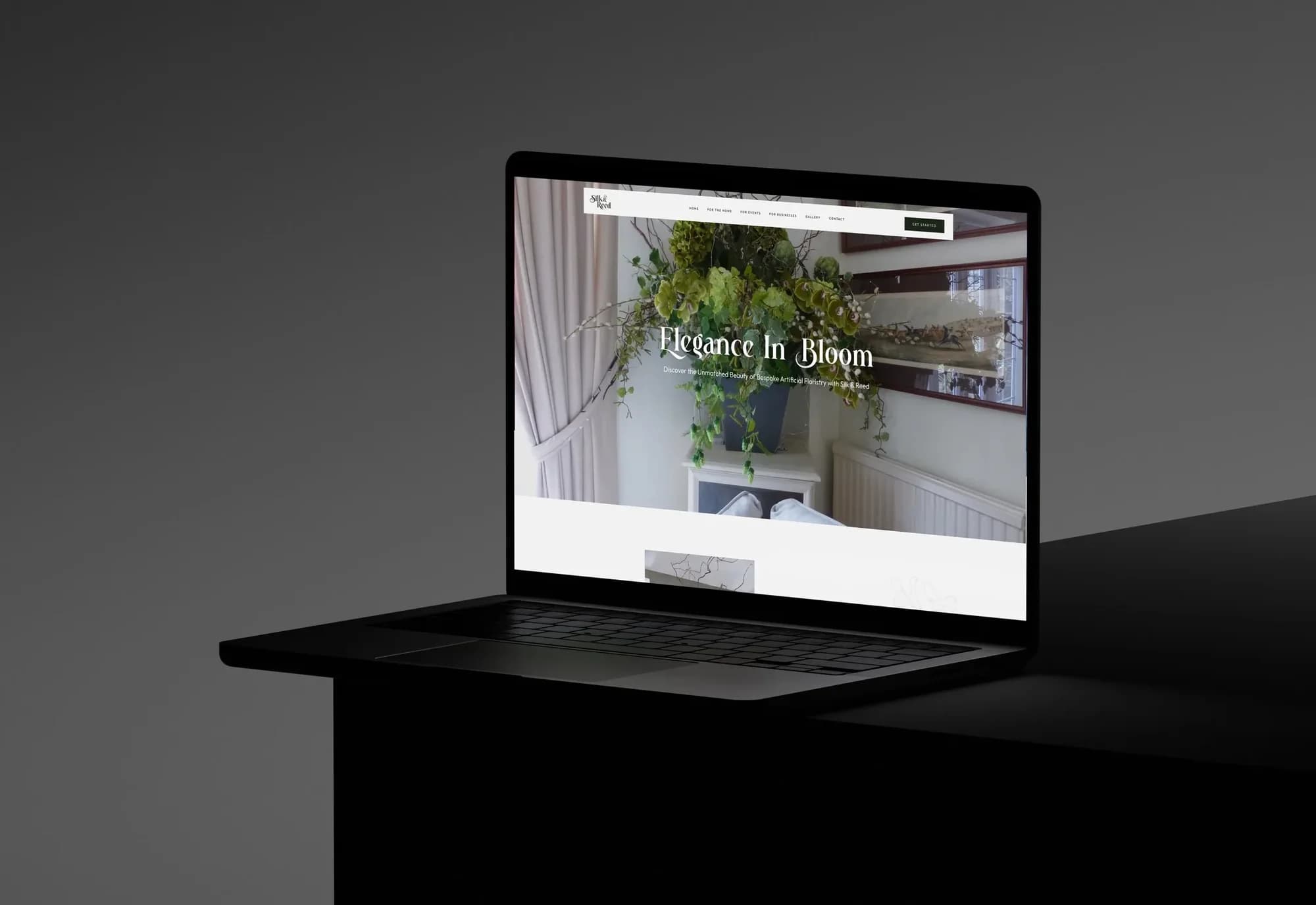 The Silk & Reed homepage on a laptop: Elegance In Bloom over a large green arrangement