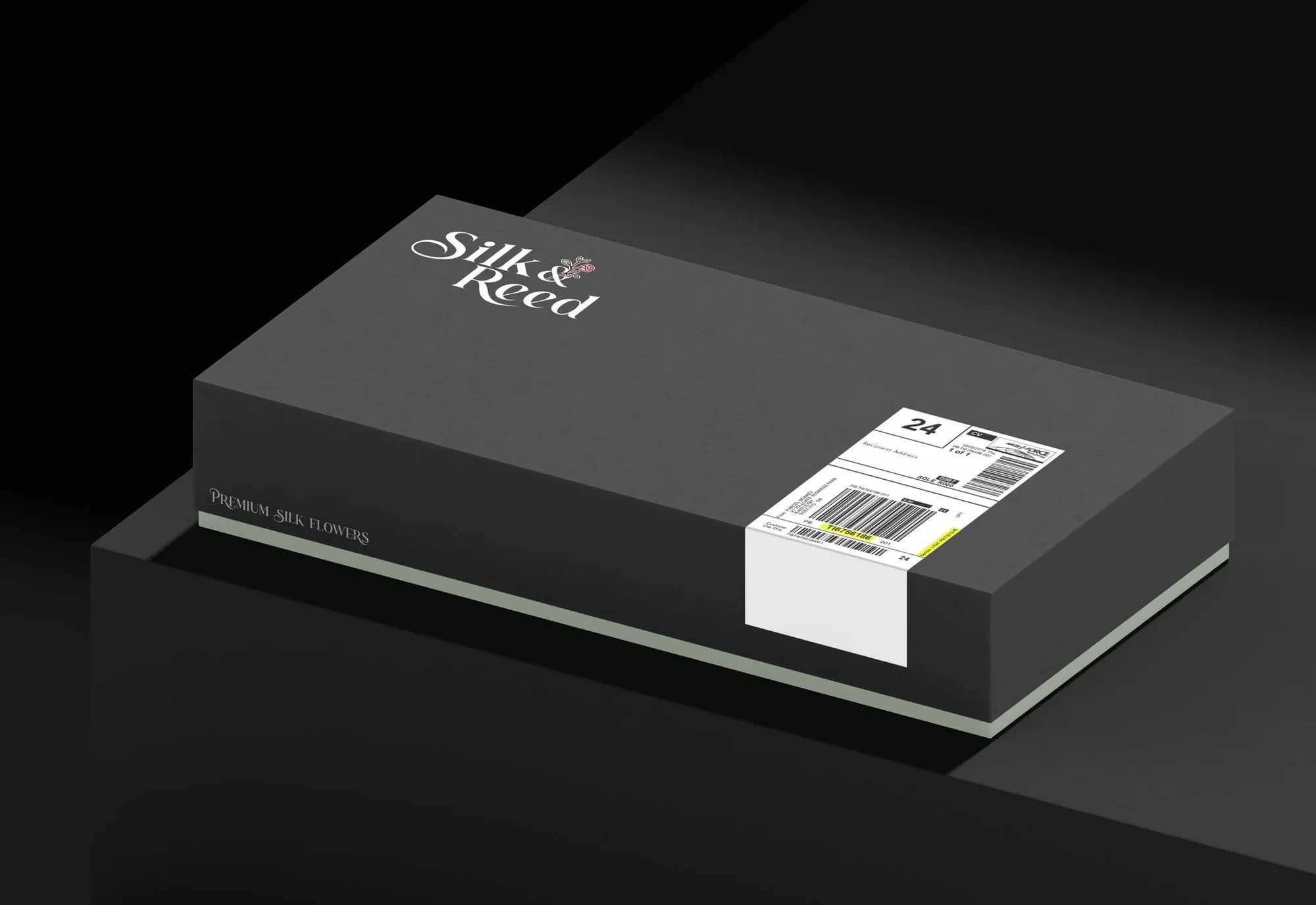 A black Silk & Reed mailer box with a sage base and a delivery label