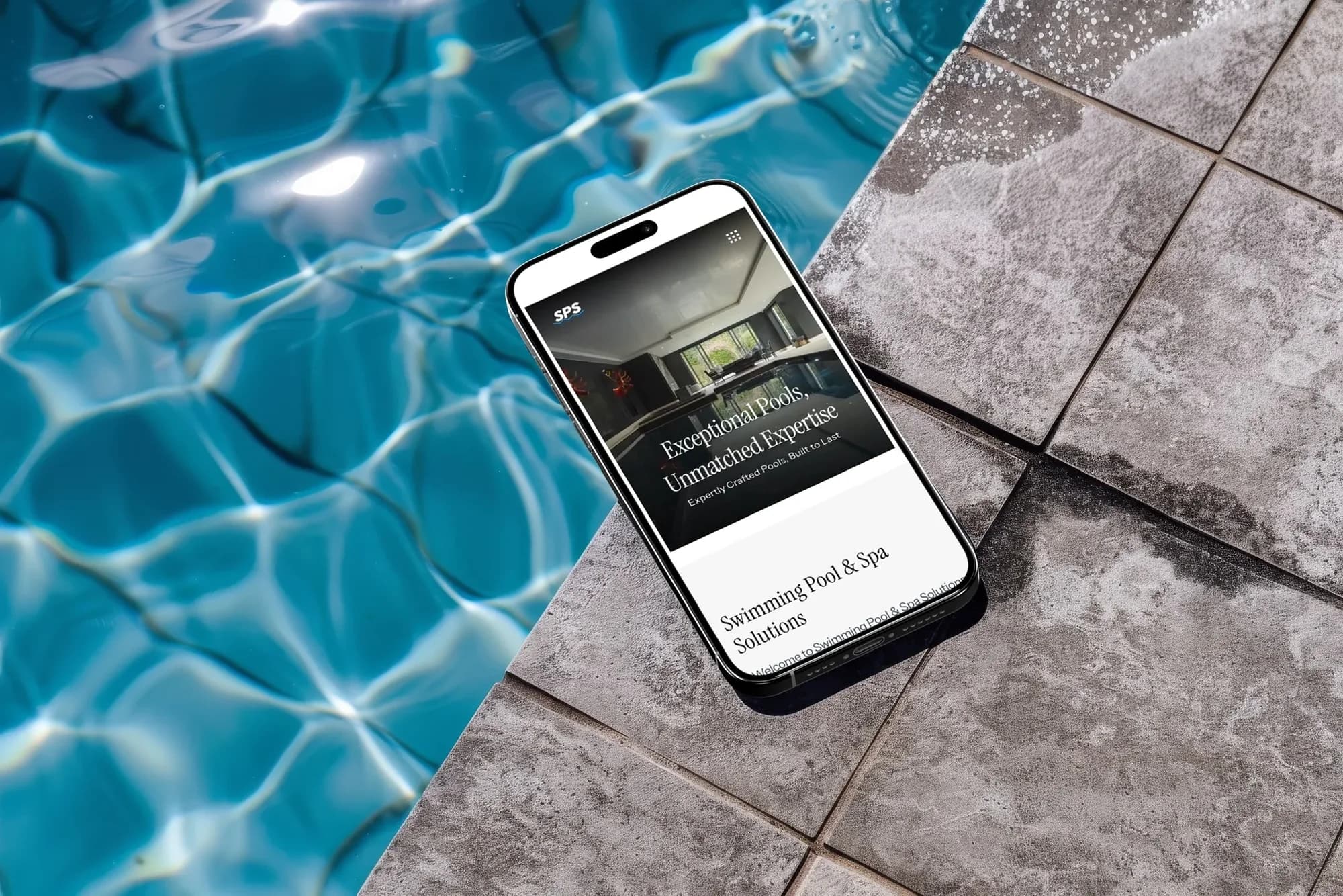 The Swimming Pool & Spa Solutions website on an iPhone lying at the edge of a pool