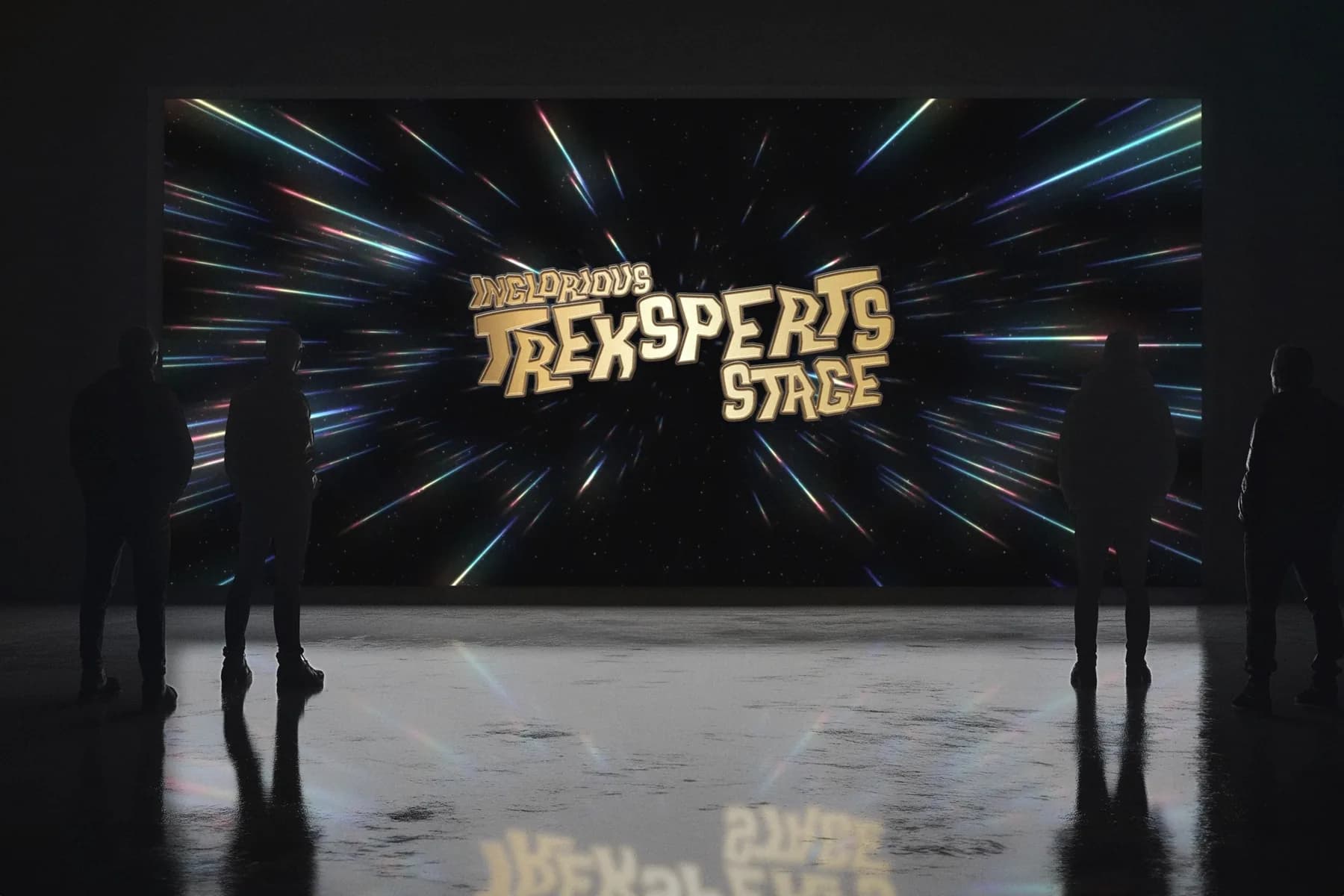 The Inglorious Treksperts Stage logo on a giant screen, with silhouetted visitors watching