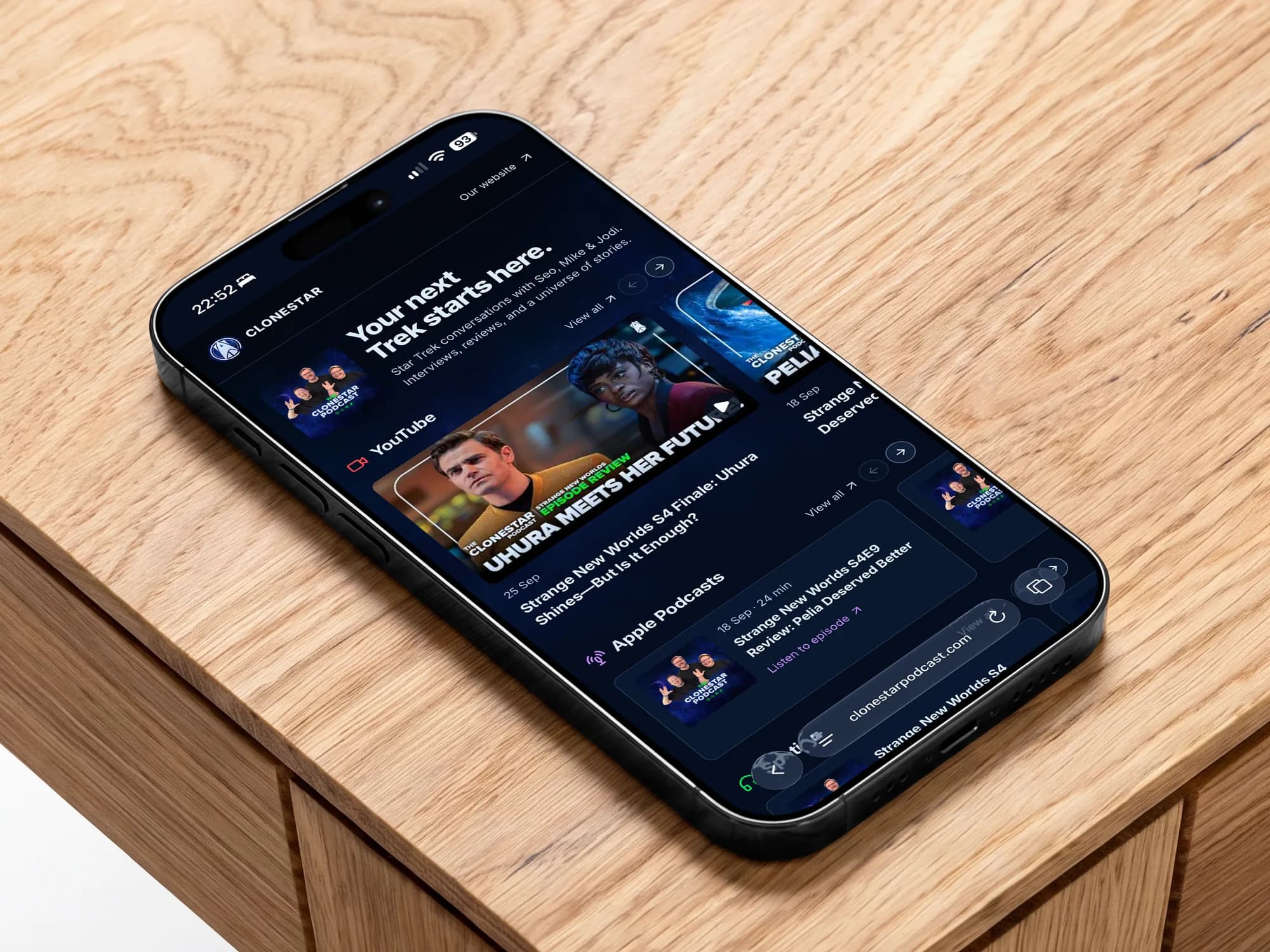 The Clonestar Podcast website on an iPhone on an oak table: your next Trek starts here