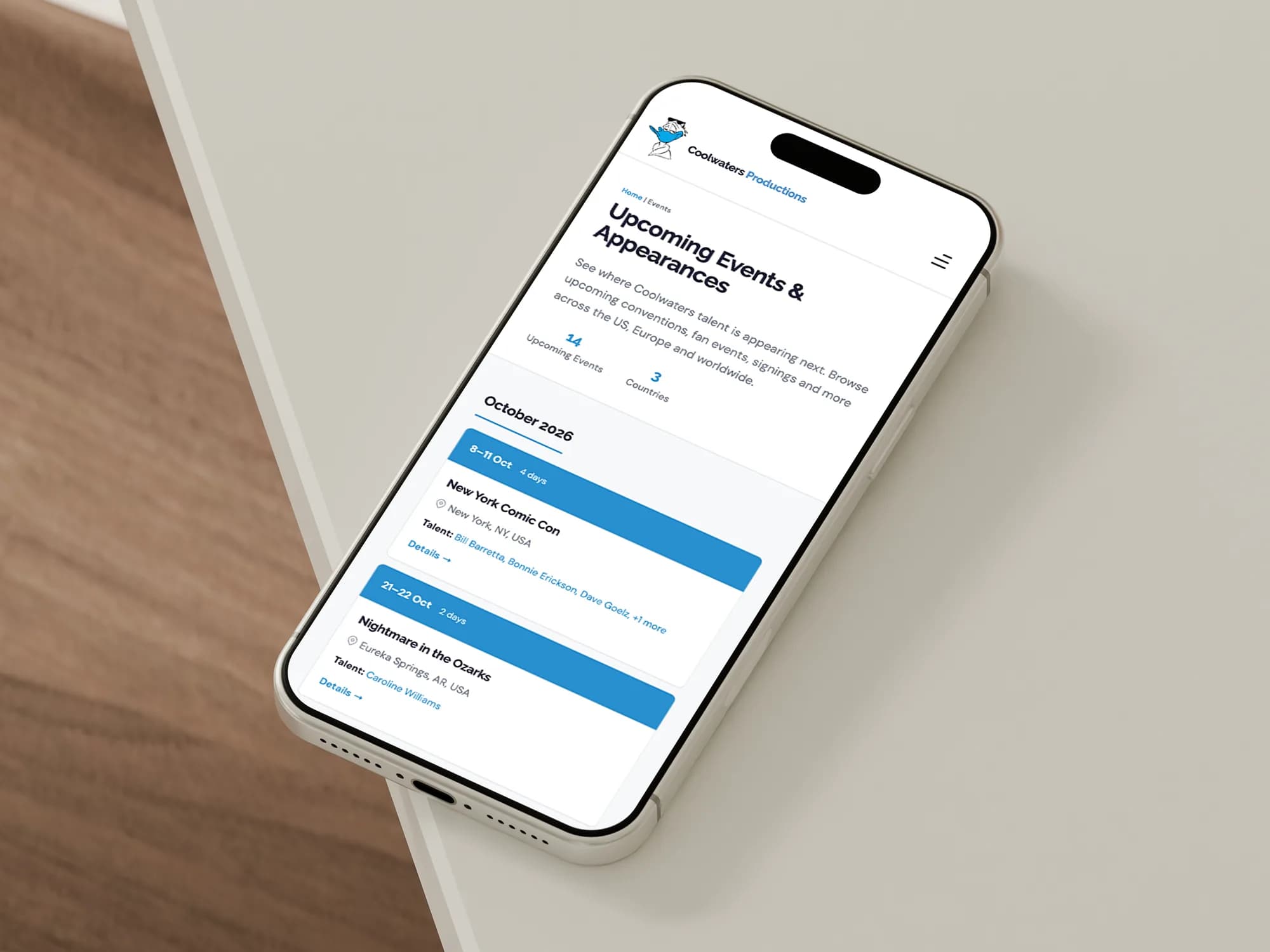 The Coolwaters upcoming events page on a phone, lying on a desk