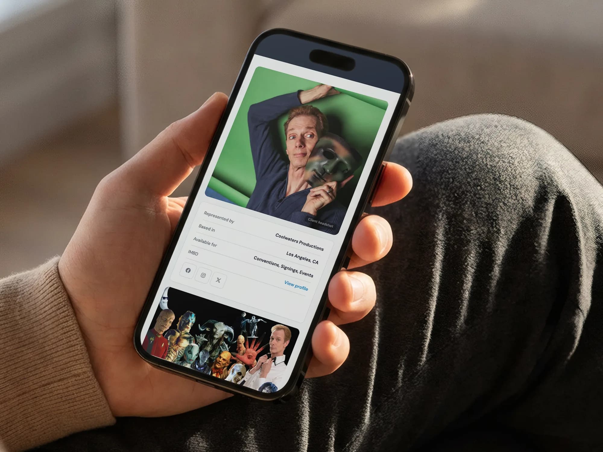 A Coolwaters client profile for Doug Jones on a phone, held in one hand by a window