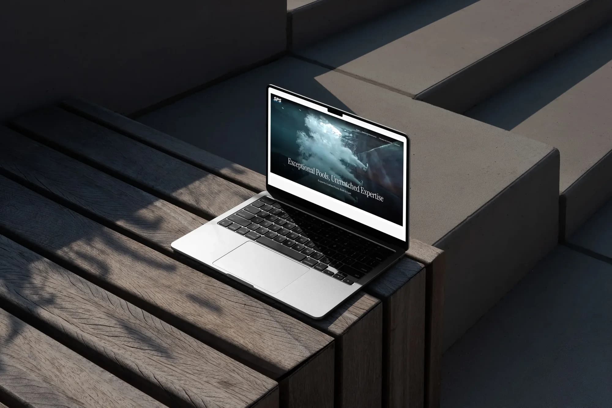 The SPS homepage on a MacBook: Exceptional Pools, Unmatched Expertise, over an underwater photo