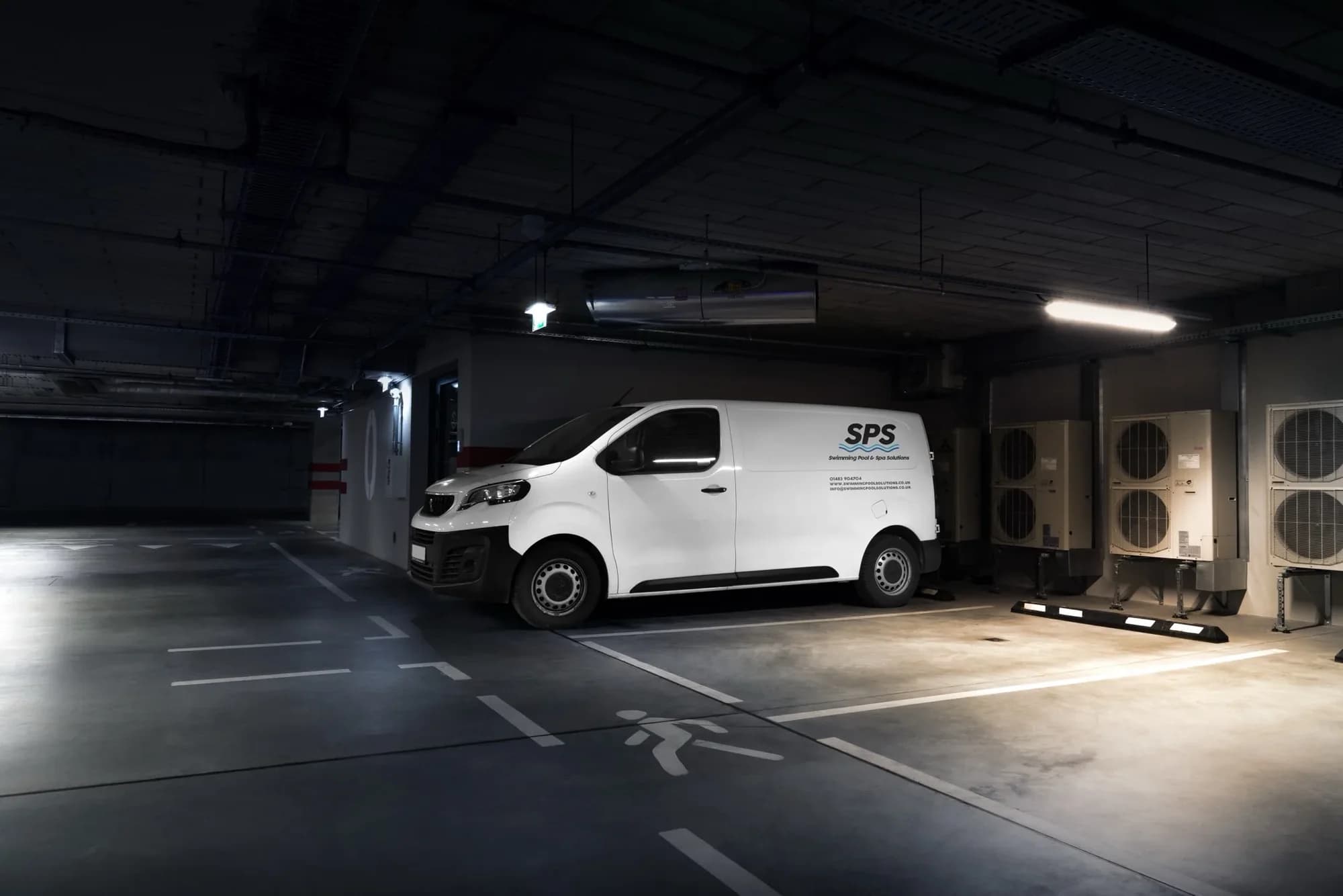 A white SPS van with the logo, phone number, website and email on the side