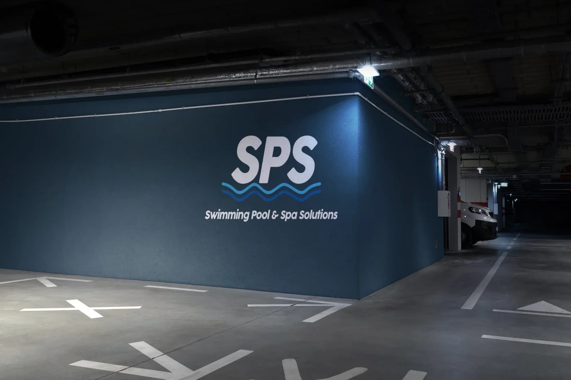 The SPS logo painted large on a navy wall in an underground car park